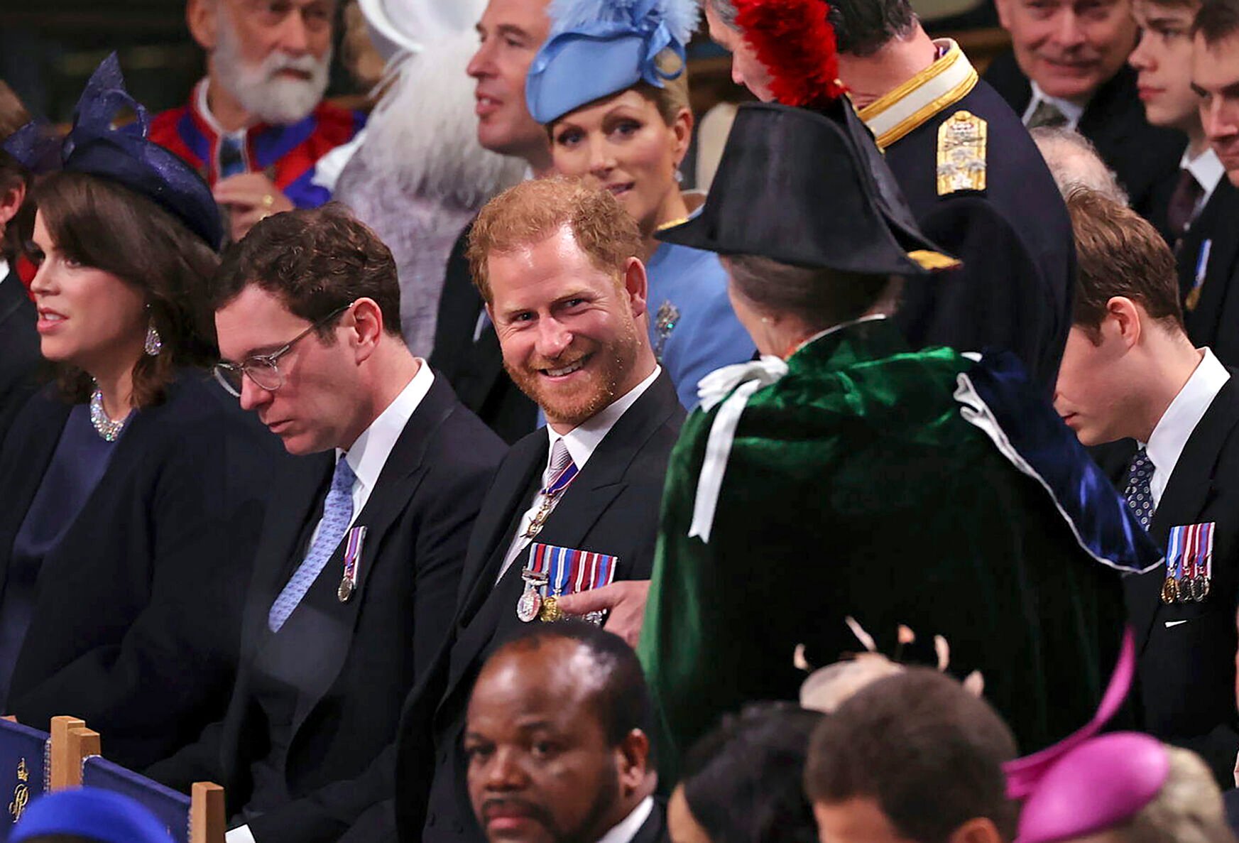 <p>Prince Harry, center, speaks with Anne, the Princess Royal on Saturday in Westminster Abbey before the coronation of King Charles III and Queen Camilla.</p>