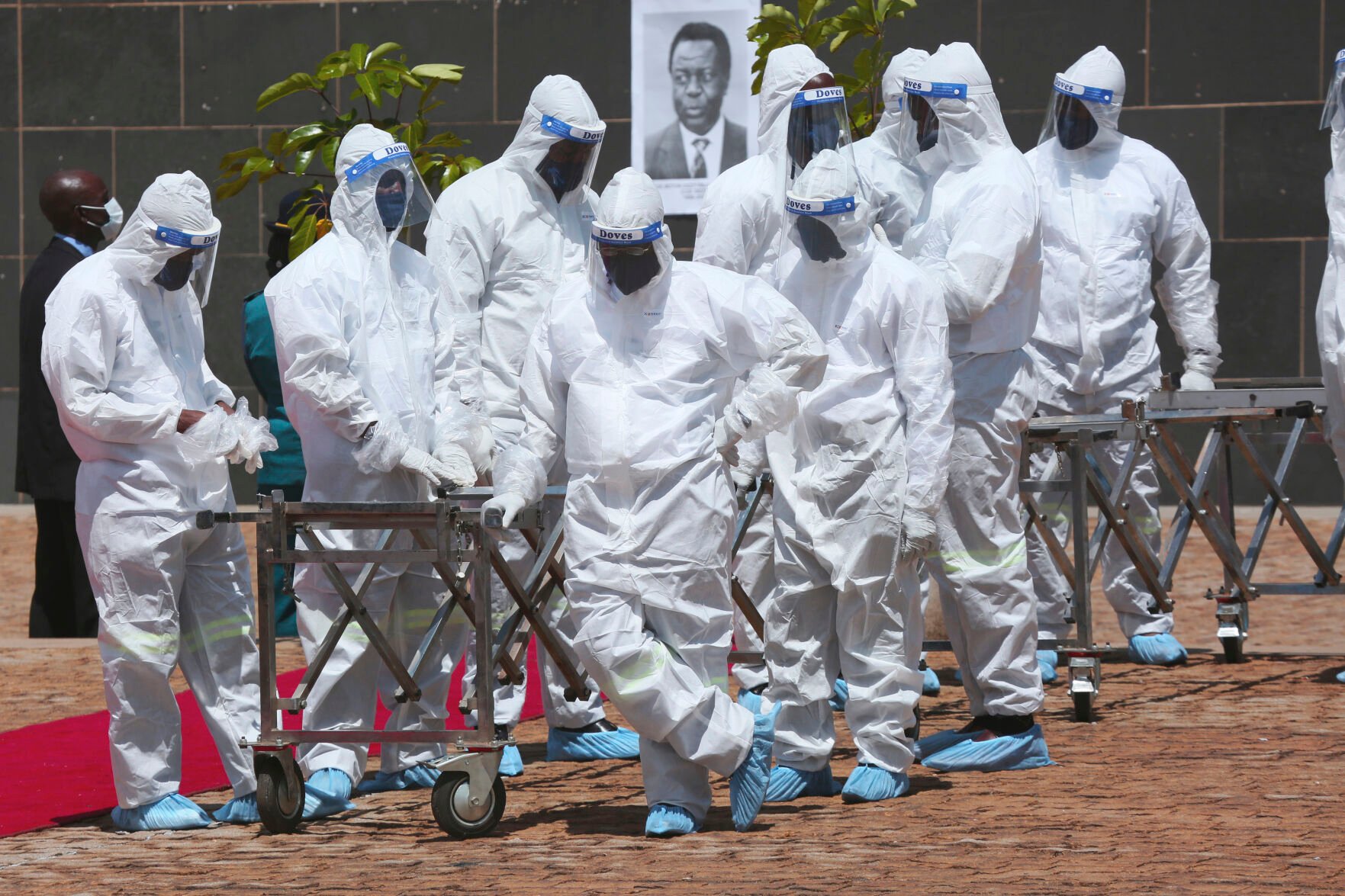 <p>Pallbearers wait for coffins to arrive Jan. 21, 2021, at a state burial of government ministers who died of COVID-19 in Harare, Zimbabwe.</p>