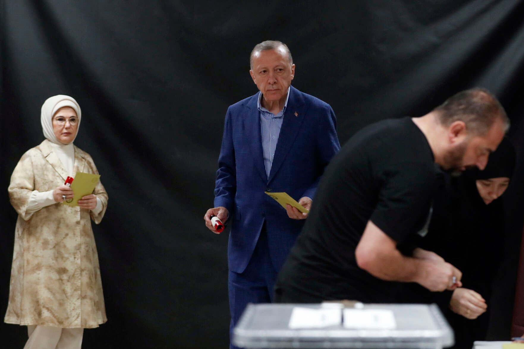 <p>Turkish President Recep Tayyip Erdogan, center, and his wife Emine Erdogan, left, wait to cast their ballots at a polling station during the second round of the presidential election in Istanbul, Sunday, May 28, 2023. Voters in Turkey returned to the polls Sunday to decide whether the country’s longtime leader, Erdogan, stretches his increasingly authoritarian rule into a third decade, or is unseated by a challenger who has promised to restore a more democratic society.</p>