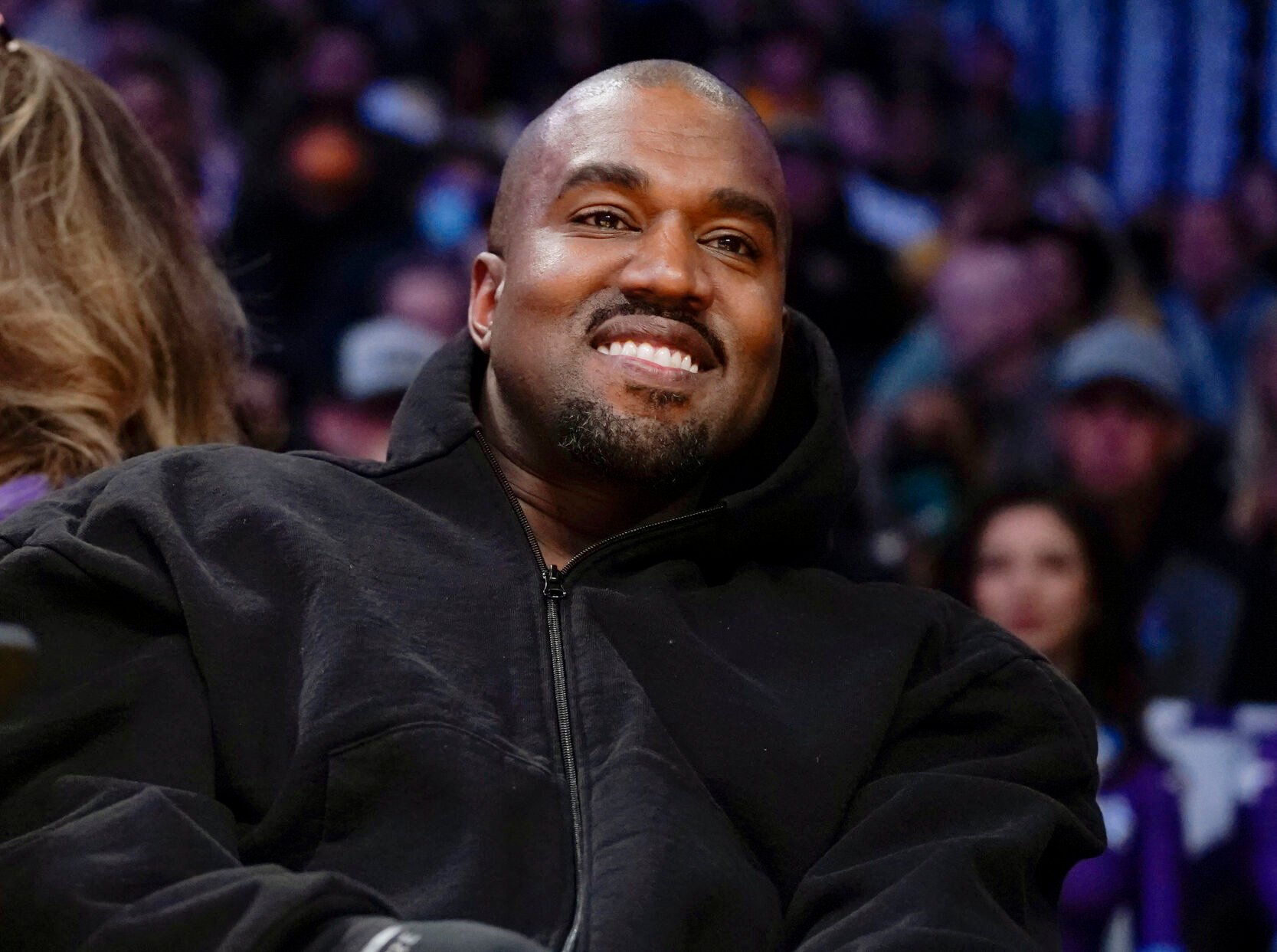 <p>Kanye West, known as Ye, watches the first half of an NBA basketball game between the Washington Wizards and the Los Angeles Lakers on March 11, 2022, in Los Angeles.</p>