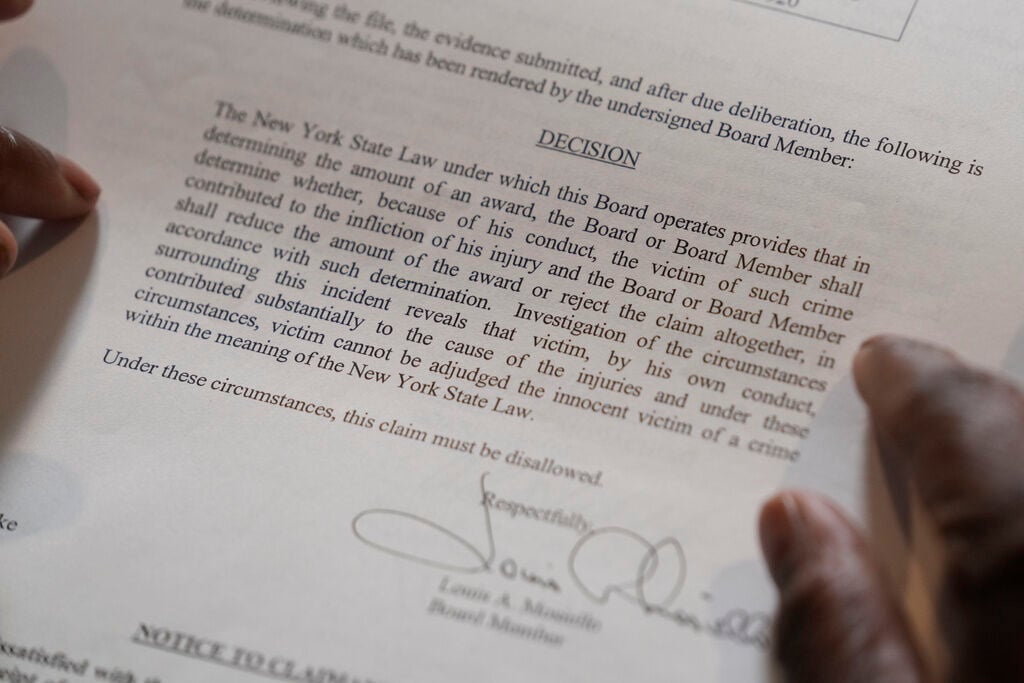 <p>In this April 19 photo, Debra Long of Poughkeepsie, N.Y., holds the letter that explains why she was initially denied reimbursement for the funeral of her son, Randy Long, who was murdered in 2006.</p>