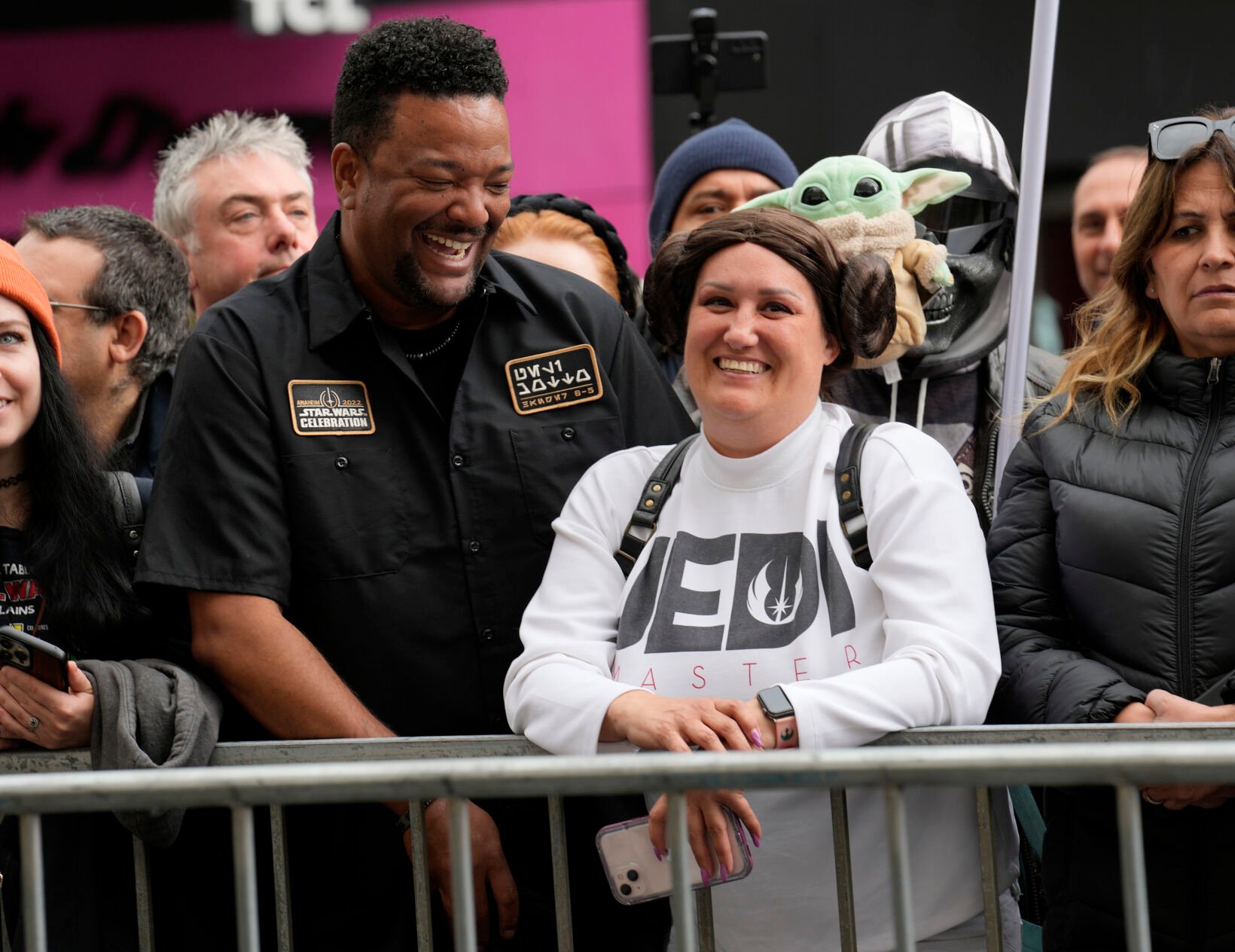 <p>Otis Farrell, left, and Bertha Channell of Anaheim, Calif., dressed in "Star Wars" costumes, wait on the sidewalk Thursday before a ceremony honoring the late actress Carrie Fisher with a star on the Hollywood Walk of Fame in Los Angeles.</p>