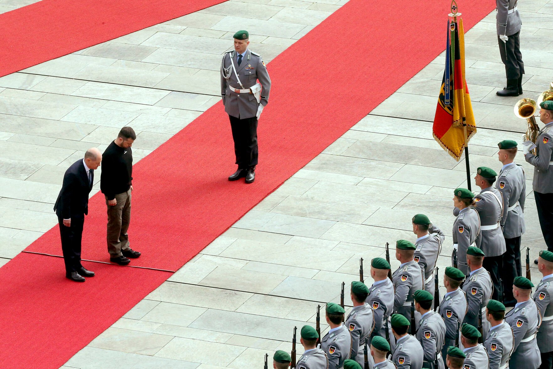 <p>Ukrainian President Volodymyr Zelenskyy, center, and German Chancellor Olaf Scholz, left, review the honor guard at the Federal Chancellery on Sunday in Berlin.</p>