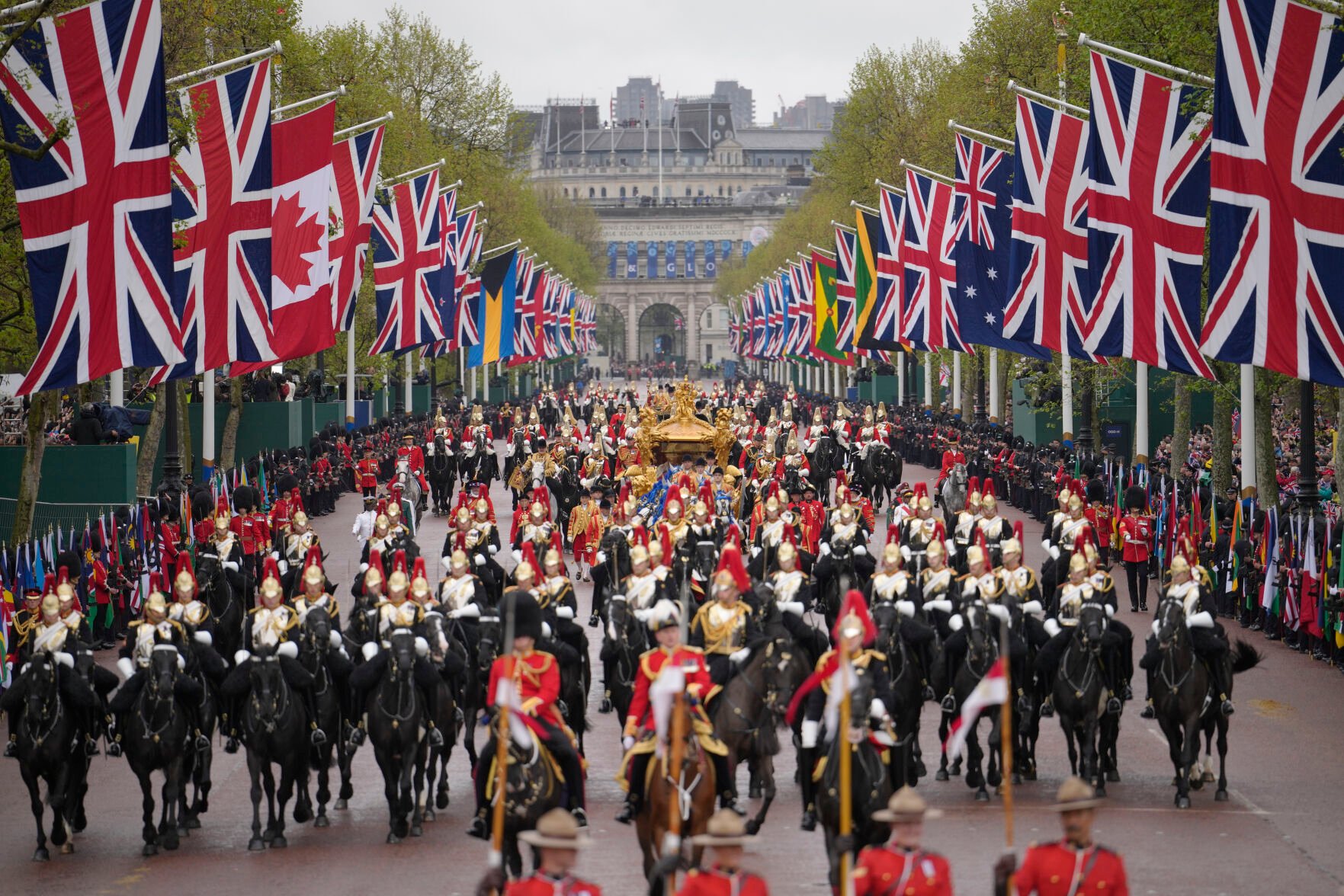 <p>A procession heads toward Buckingham Palace after the coronation ceremony for Britain's King Charles III and Queen Camilla on Saturday in London.</p>