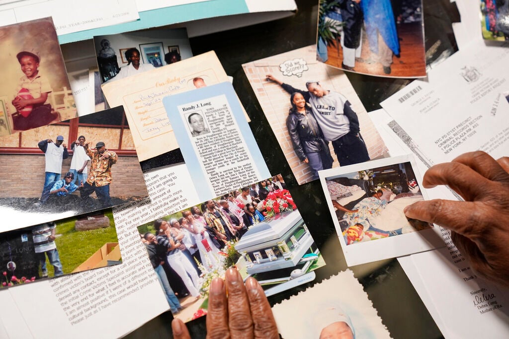 <p>Debra Long looks through documents about the murder of her son, Randy Long, and photographs from his life, at her home in Poughkeepsie, N.Y., on April 19, 2023.</p>