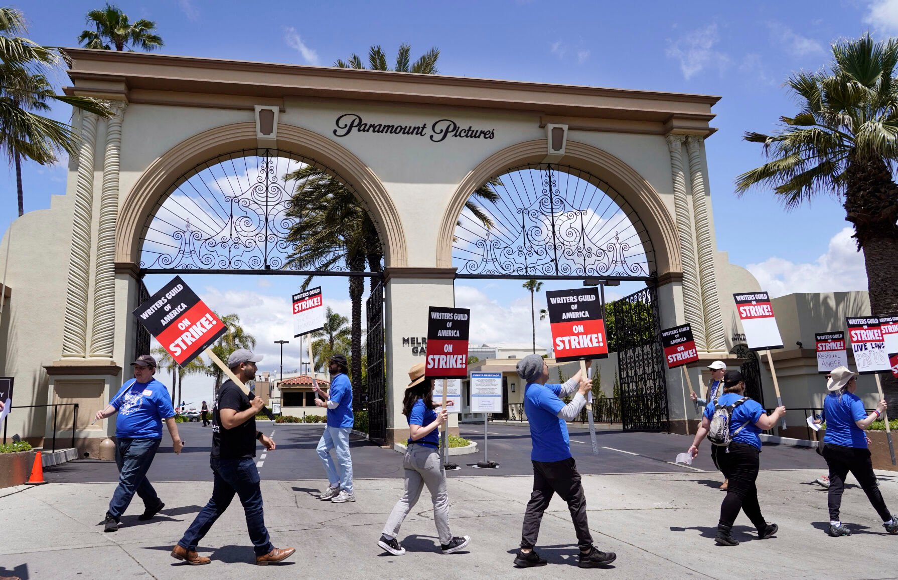 <p>Members of the The Writers Guild of America West picket at an entrance to Paramount Pictures on Tuesday in Los Angeles. </p>