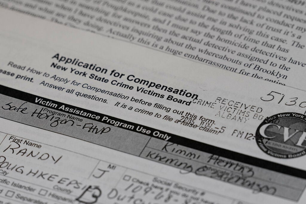 <p>Paperwork and letters relating to the case of Randy Long, who was murdered in 2006, are shown by his mother, Debra Long, in Poughkeepsie, N.Y., on April 19.</p>