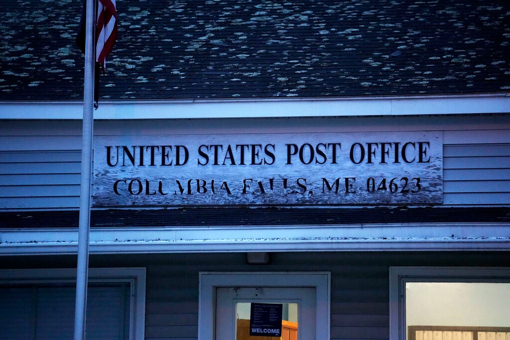 <p>A weathered sign at the post office in Columbia Falls, Maine, April 27.</p>
