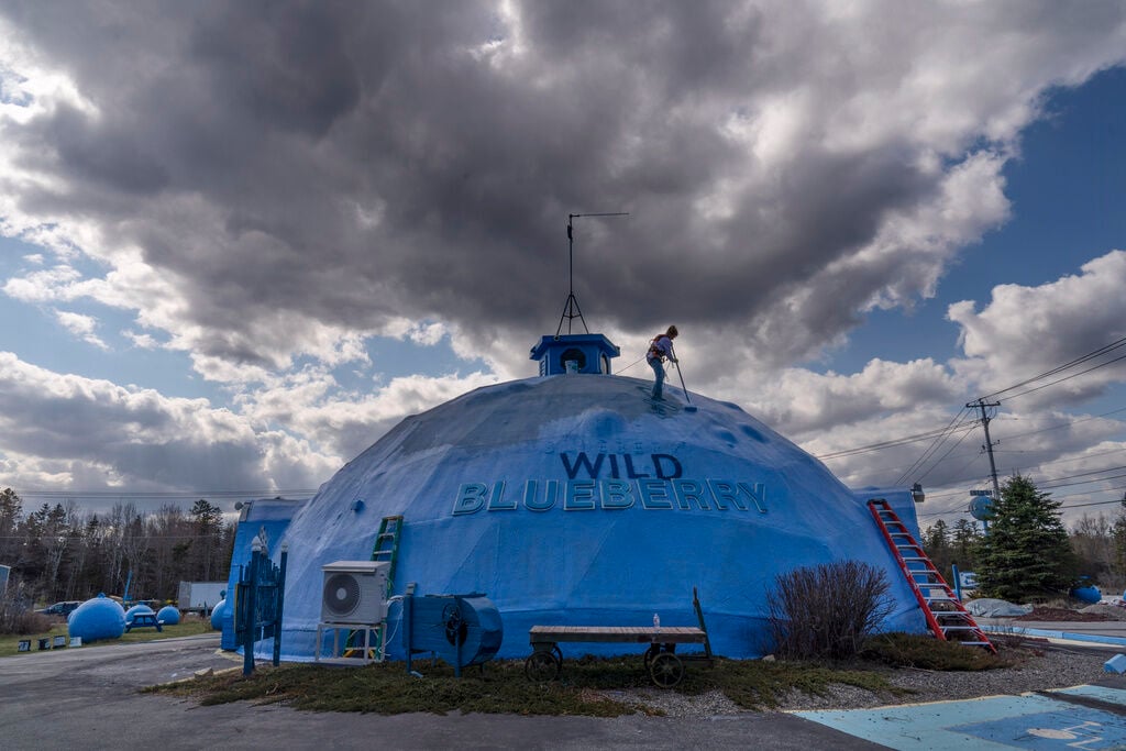 <p>A fresh coat of paint is applied to a dome building at the Wild Blueberry Heritage Center in Columbia Falls, Maine, on April 27. Blueberries and fishing are the major industries in Down East Maine.</p>