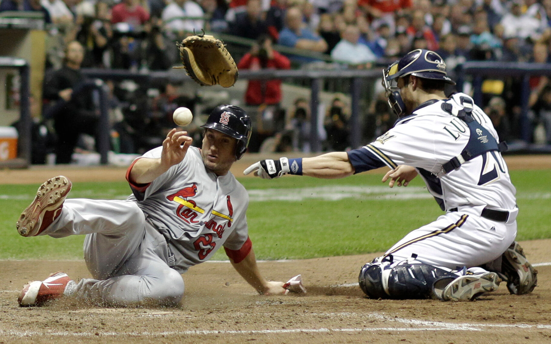 <p>St. Louis Cardinals' David Freese knocks the glove and ball away from Milwaukee Brewers catcher Jonathan Lucroy as he scores on a sacrifice fly by Adron Chambers during Game 6 of the 2011 NLCS in Milwaukee.</p>