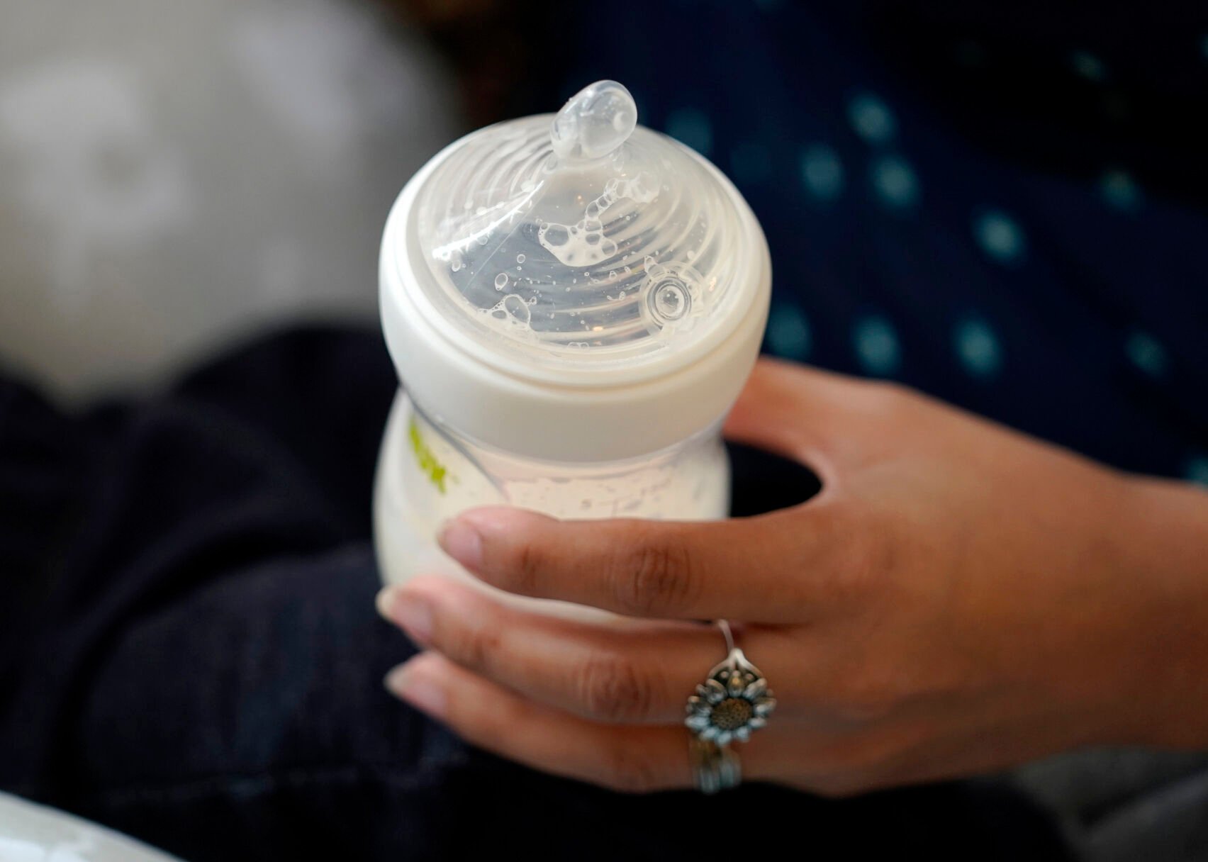 <p>A woman holds a bottle of baby formula as she feeds her infant son May 13, 2022, in San Antonio, Texas.</p>
