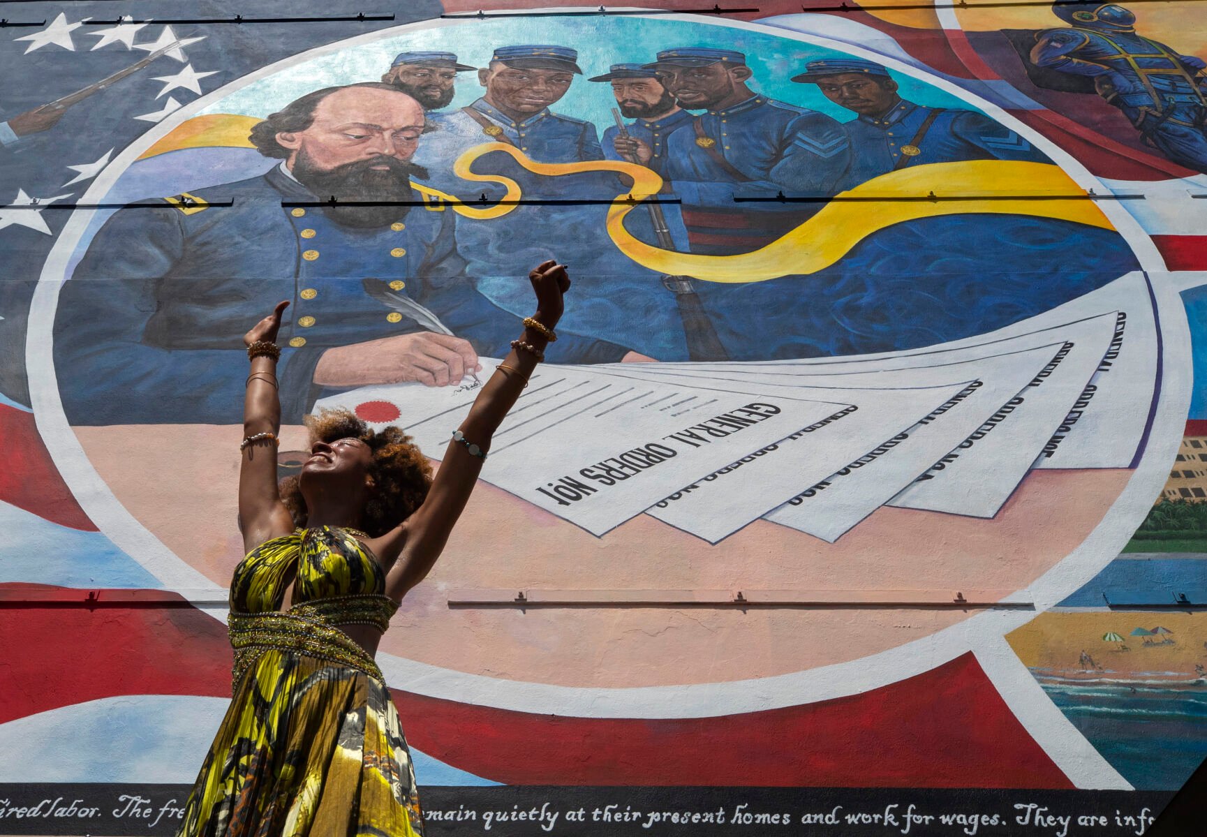 <p>FILE - Dancer Prescylia Mae, of Houston, performs during a dedication ceremony for the massive mural "Absolute Equality" in downtown Galveston, Texas, on June 19, 2021. Communities all over the country will be marking Juneteenth, the day that enslaved Black Americans learned they were free. For generations, the end of one of the darkest chapters in U.S. history has been recognized with joy in the form of parades, street festivals, musical performances or cookouts. Yet, the U.S. government was slow to embrace the occasion. (Stuart Villanueva/The Galveston County Daily News via AP, File)</p>
