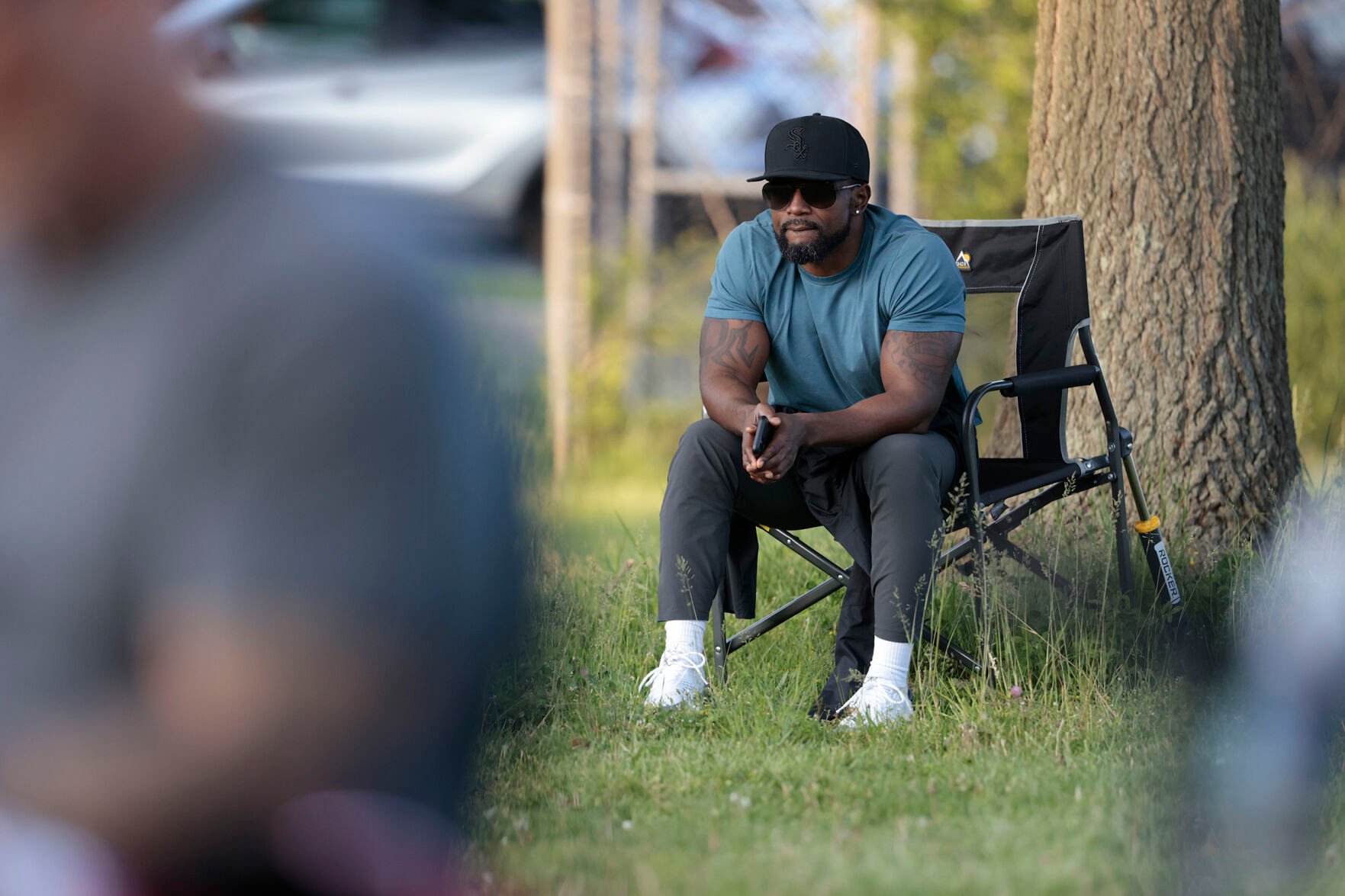 <p>Devon Goree watches his son's youth baseball game at the Deptford Little League complex in Deptford, N.J., May 10.</p>
