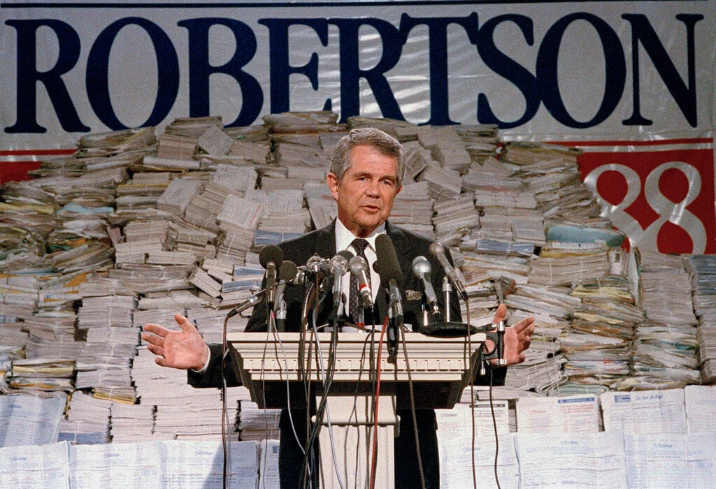 <p>FILE - Pat Robertson, stands in front of stacks of signatures as he announced his intentions to collect a total of 7 million signatures during a news conference on Sept. 15, 1987 in Chesapeake, Va. Robertson, a religious broadcaster who turned a tiny Virginia station into the global Christian Broadcasting Network, tried a run for president and helped make religion central to Republican Party politics in America through his Christian Coalition, has died. He was 93. Robertson's death Thursday, June 8, 2023 was announced by his broadcasting network. (AP Photo/Steve Helber, file)</p>