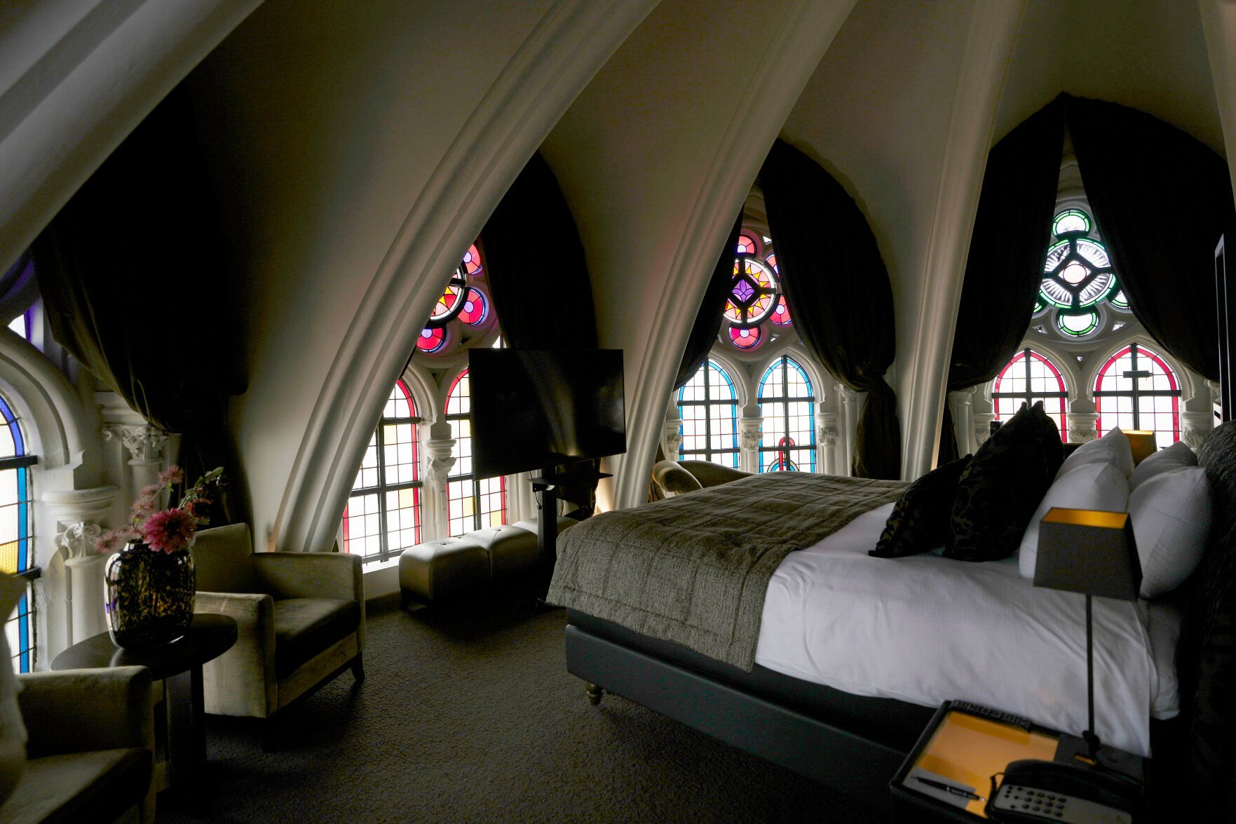 <p>Sunlight filters in through stained glass windows in a guest room at the Martin's Patershof hotel in the center of Mechelen, Belgium, Monday, June 19, 2023. Across Europe, the continent that nurtured Christianity for most of two millennia, many churches, convents, beguinages and chapels stand empty as faith and church attendance have dwindled over the past half century. Many are now been repurposed to preserve their historical and architectural relevance, while others have opened up to non-religious activities to expand their use. (AP Photo/Virginia Mayo)</p>