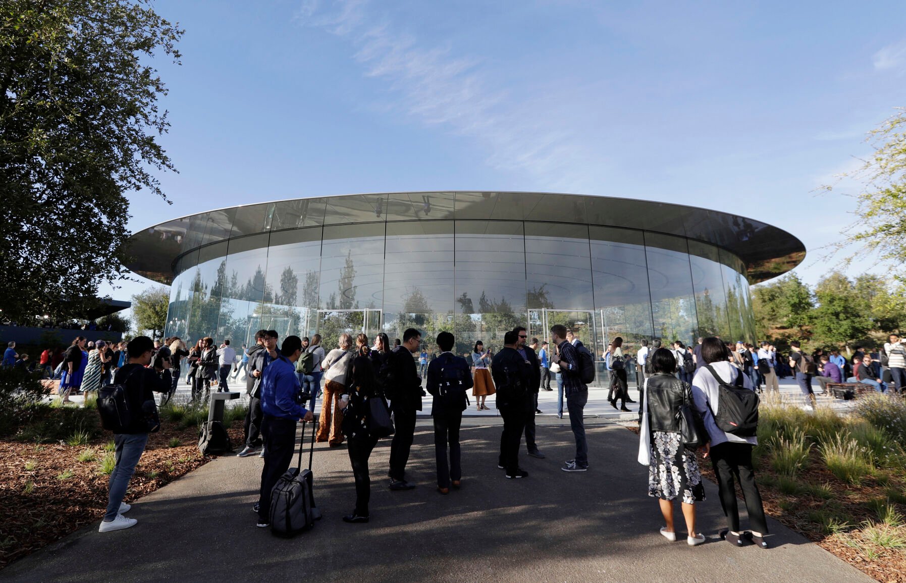 <p>People stand outside of the Steve Jobs Theater before an event on Wednesday, Sept. 12, 2018, in Cupertino, Calif. </p>