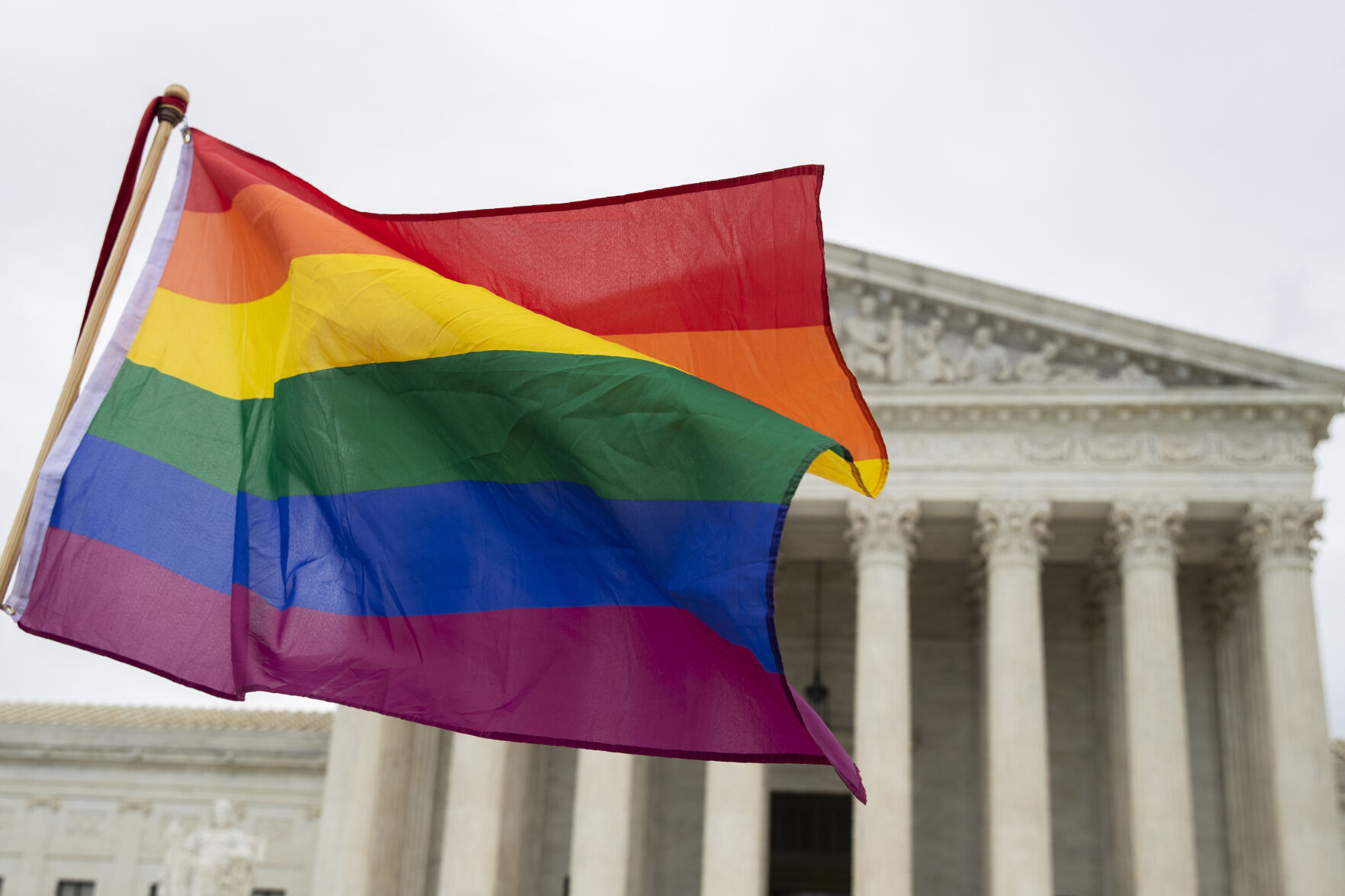 <p>FILE - Supporters wave a pride flag in front of the U.S. Supreme Court, Oct. 8, 2019, in Washington.</p>