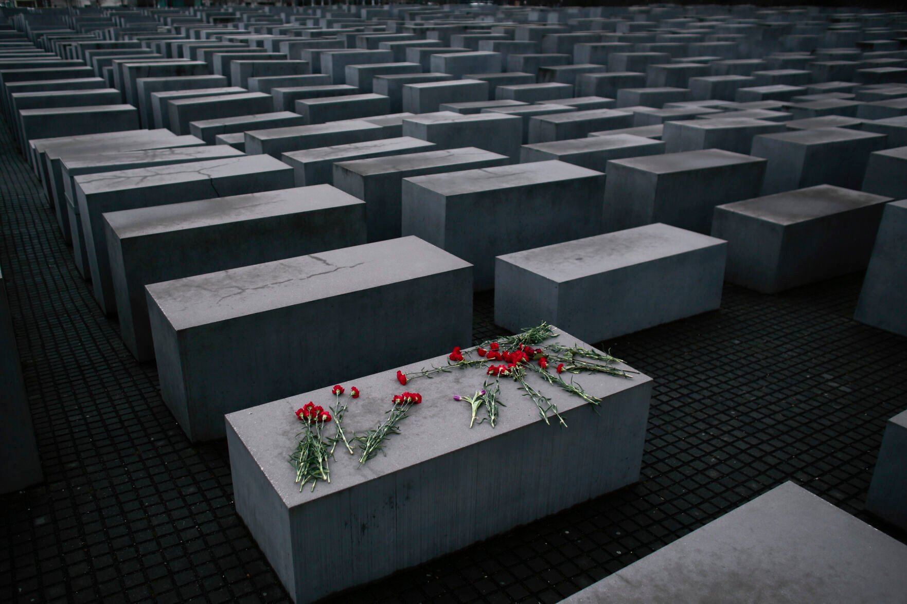 <p>Flowers lie on a concrete slab of the Holocaust Memorial to mark the International Holocaust Remembrance Day and commemorating the 70th anniversary of the liberation of the Nazi Auschwitz death camp in Berlin, on Jan. 27, 2015. </p>