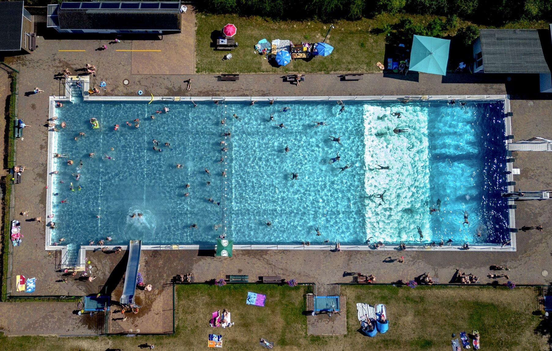 <p>People spend time in a public pool July 8 in Wehrheim near Frankfurt, Germany.</p>