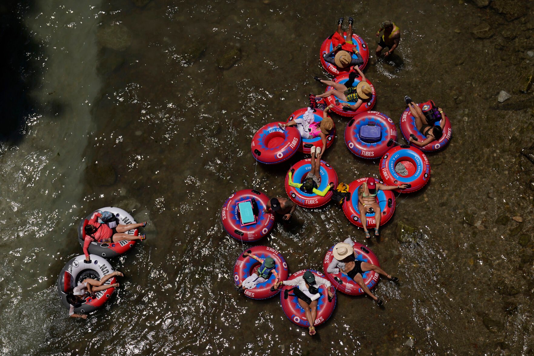 <p>Tubers float the Comal River on Thursday in New Braunfels, Texas, to try to beat the heat.</p>