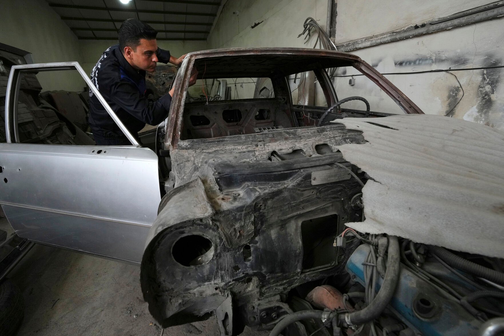 <p>Khosro Dahaghin inspects an under-restored Cadillac Seville at his workshop in Roudehen, Iran, on June 7. The Sevilles, once assembled in Iran, represented the height of luxury in the country just before the 1979 Islamic Revolution.  </p>