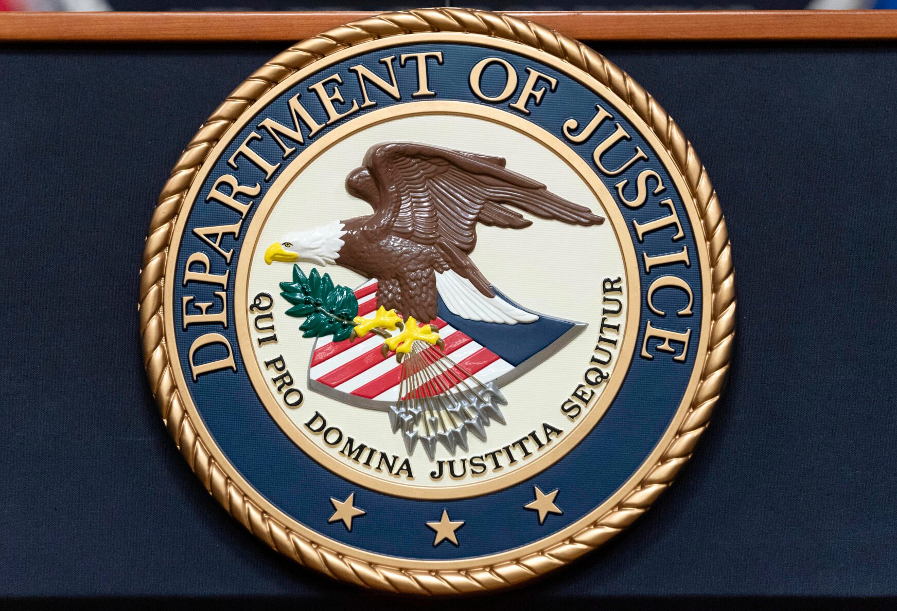 <p>FILE - The Department of Justice seal is seen before a news conference to announce an international ransomware enforcement action at the Department of Justice in Washington, Jan. 26, 2023. On Friday, July 21, The Associated Press reported on stories circulating online incorrectly claiming the U.S. Department of Justice said international child sex trafficking is not an area of concern. (AP Photo/Jose Luis Magana, File)</p>