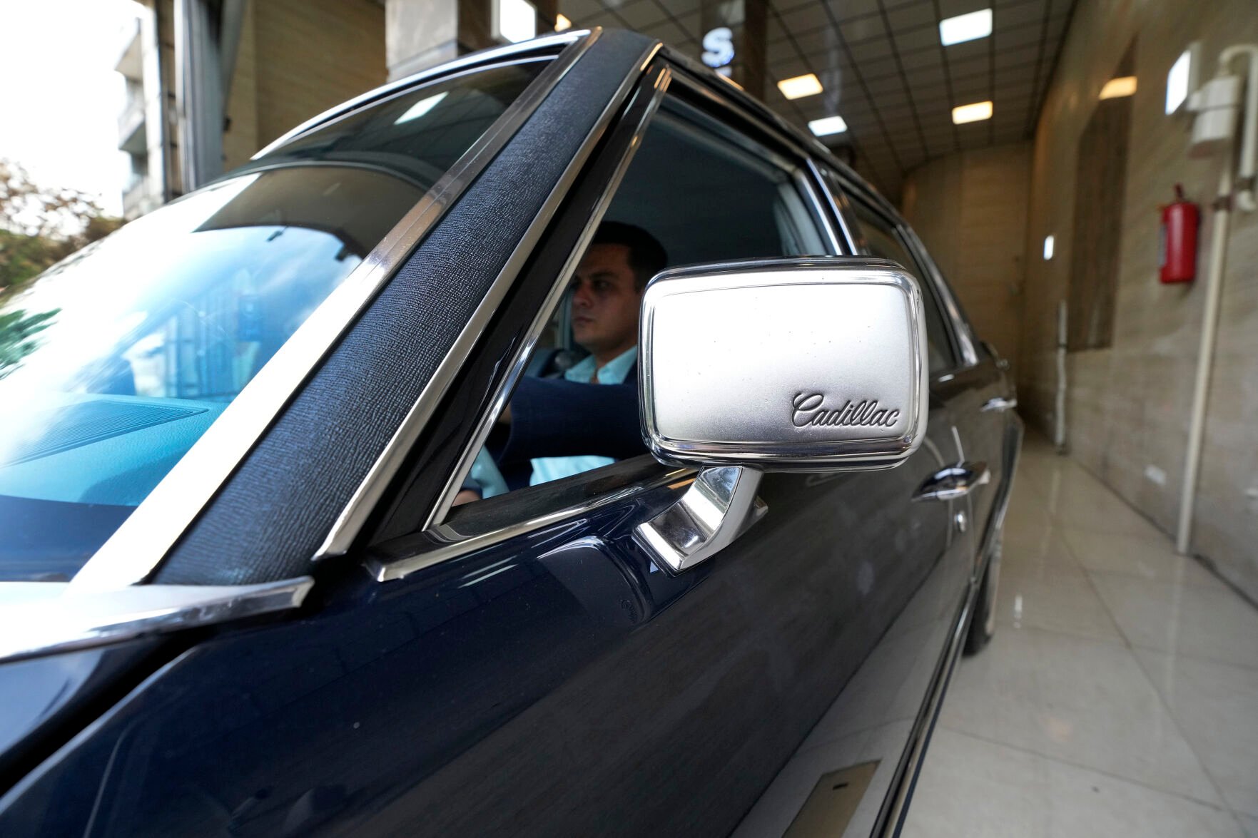 <p>Khosro Dahaghin drives out his restored Cadillac Seville at his dealership store in Roudehen, Iran, on June 7. The Sevilles, once assembled in Iran, represented the height of luxury in the country just before the 1979 Islamic Revolution. </p>