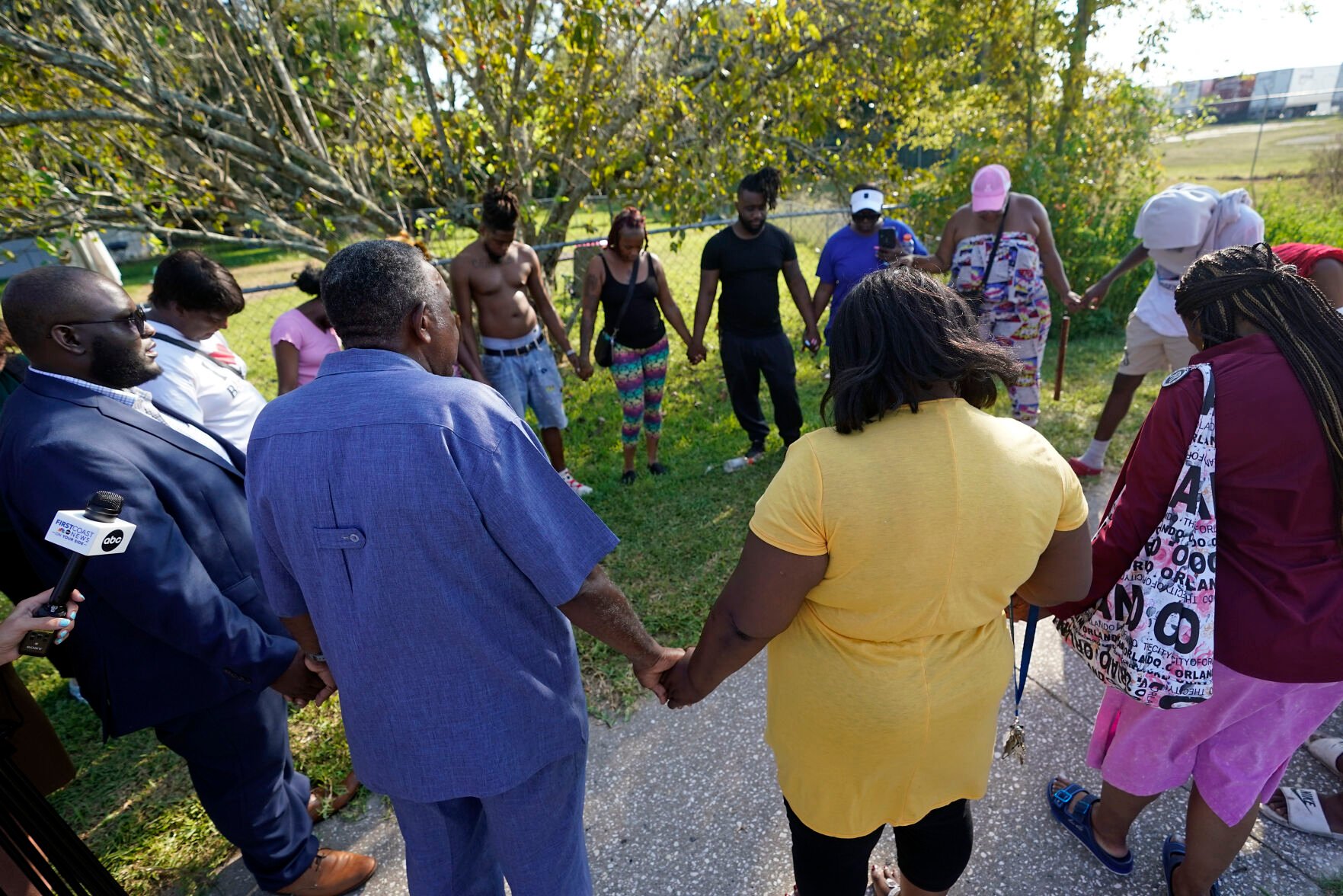 <p>Residents gather for a prayer Saturday near the scene of a shooting at a Dollar General store in Jacksonville, Fla.</p>