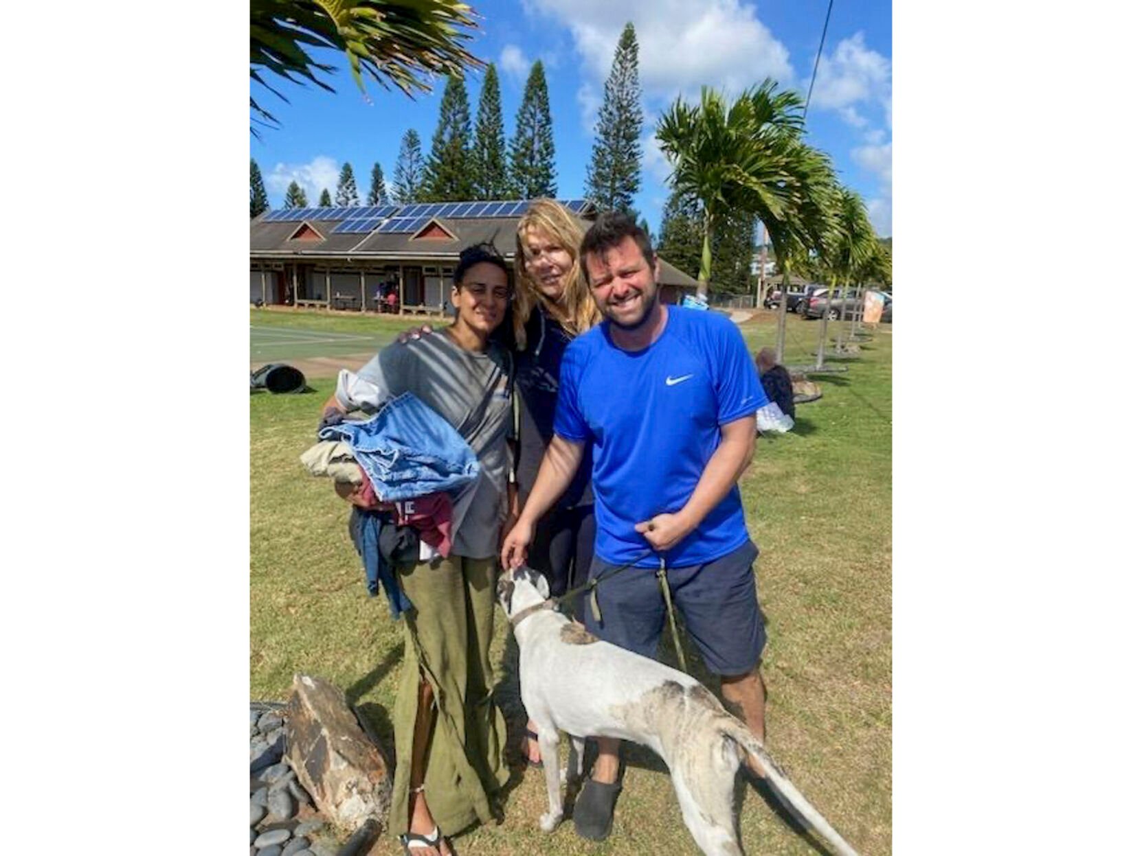 <p>This Aug. 9, 2023 photo taken by his stepfather Mike Eilers and provided by Mike Cicchino shows Mike Cicchino holding his dog Raina, right, his wife Andreza Cicchino, left and his mother Susan Ramos pose for a picture as they were reunited at shelter in Maui, Hawaii. </p>