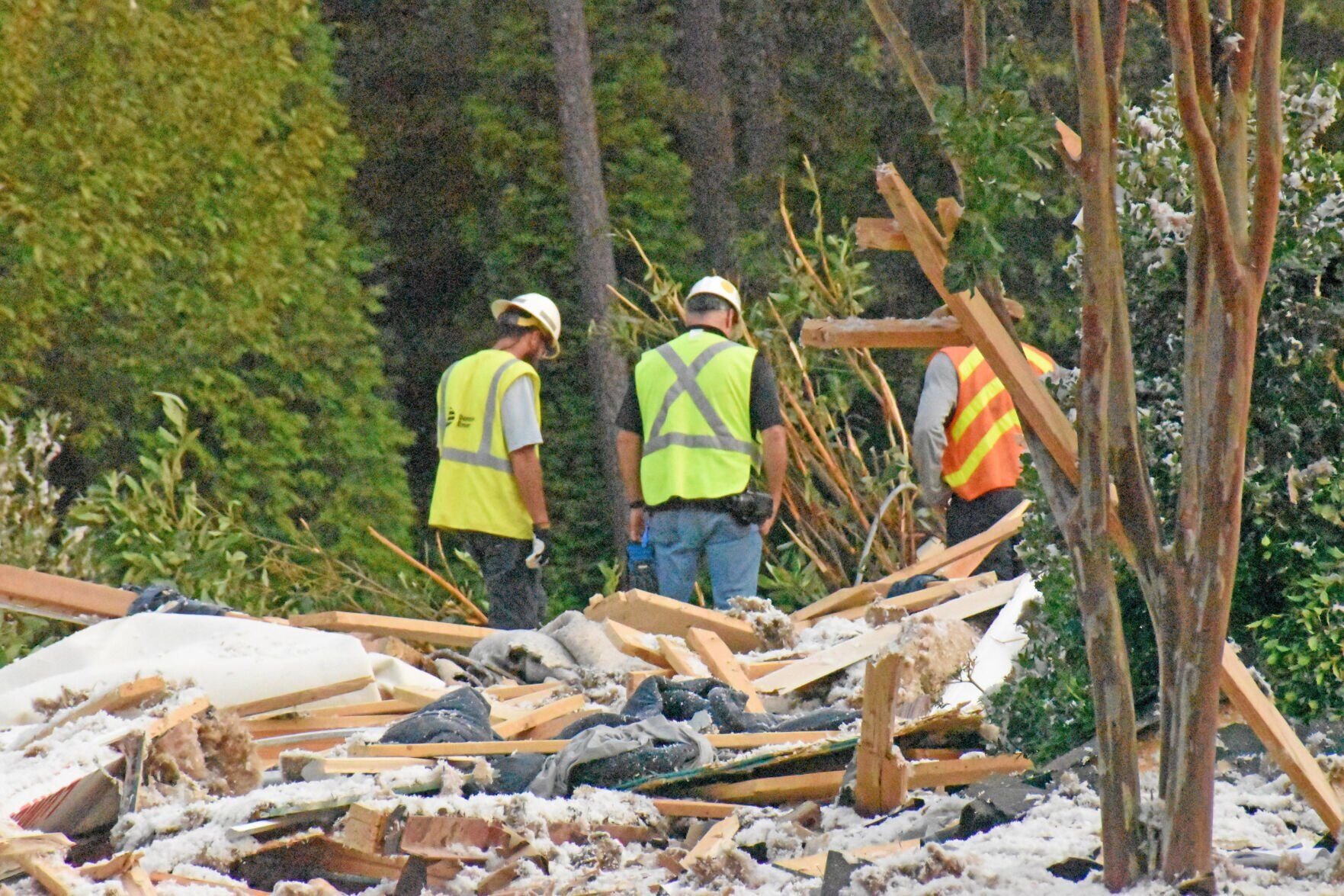 <p>Workers survey damages following a fatal home explosion on Barber Loop in Mooresville.</p>