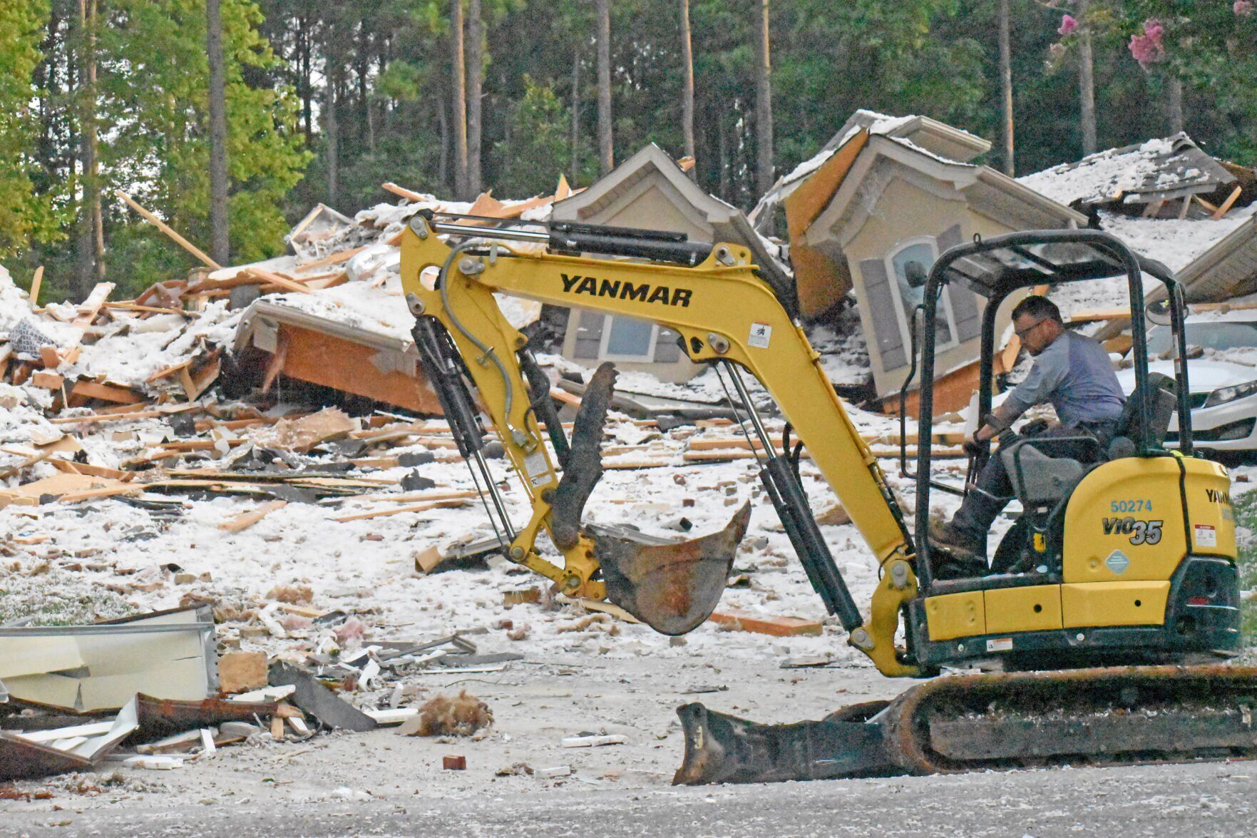<p>A worker uses an excavator to clear debris left from a home explosion at 292 Barber Loop in Mooresville.</p>