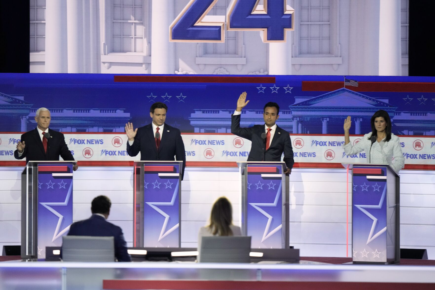 <p>Former Vice President Mike Pence, Florida Gov. Ron DeSantis, businessman Vivek Ramaswamy and former U.N. Ambassador Nikki Haley raise their hands in response to a question if they would support the eventual party nominee during a Republican presidential primary debate hosted by FOX News Channel Wednesday, Aug. 23, 2023, in Milwaukee. (AP Photo/Morry Gash)</p>