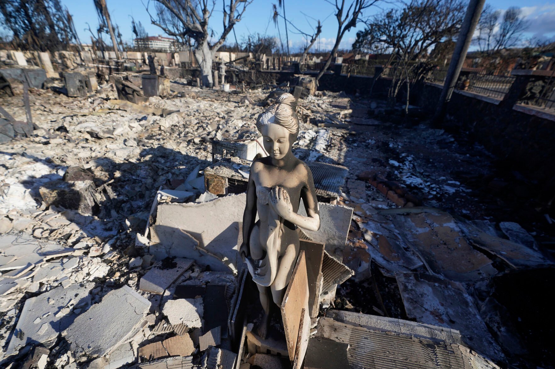 <p>A burnt statue sits amid the rubble of a home Aug. 12 in Lahaina, Hawaii, after wildfires. More than 3,000 buildings in Lahaina were damaged by fire, smoke or both. Experts predict developers and investors will research who has mortgages and said Maui residents should expect cold calls.</p>