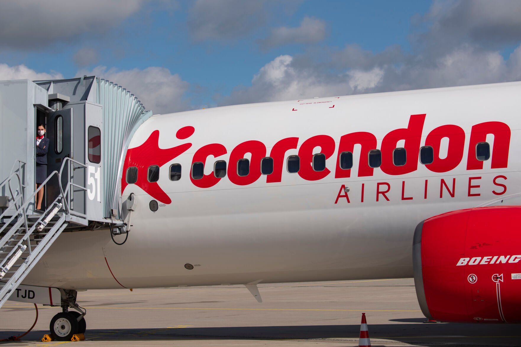 <p>Senior cabin crew member Magdalini Michailidou stands on the gangway on July 2, 2020, prior the first holiday flight of the Corendon Airlines Europe to the Greek destination Rhodos at the airport Erfurt-Weimar in Erfurt, Germany. Corendon says that it will sell an adults-only zone — no one under 16 allowed — on flights between Amsterdam and Curacao starting in November. </p>