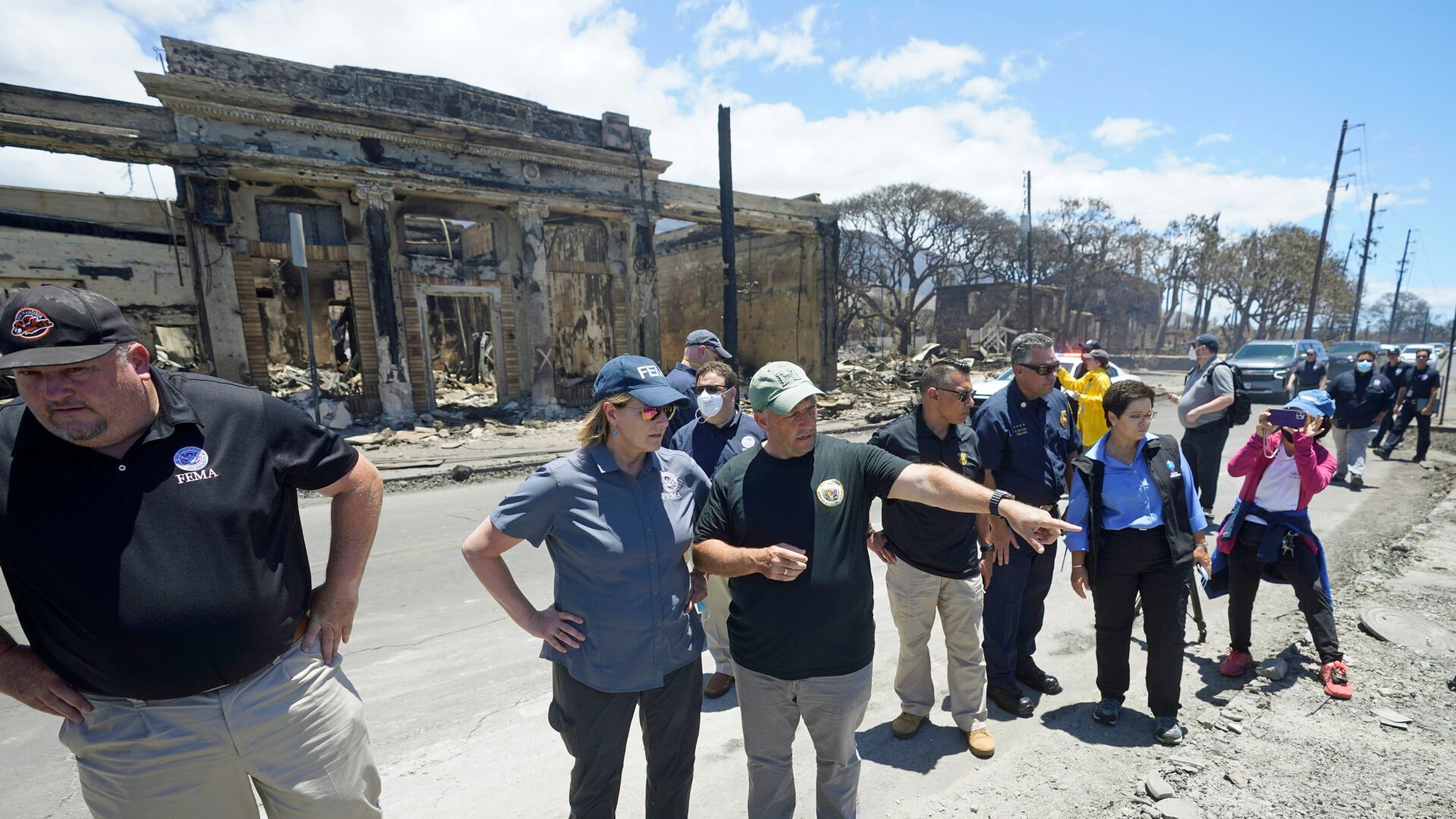 <p>Governor of Hawaii Josh Green, center, points to damage as he speaks with FEMA Administrator Deanne Criswell during a tour of wildfire damage on Saturday, Aug. 12, 2023, in Lahaina, Hawaii. (AP Photo/Rick Bowmer)</p>