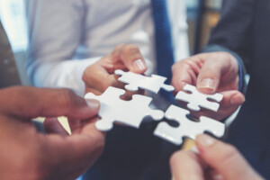Group Of Business People Holding A Jigsaw Puzzle Pieces.