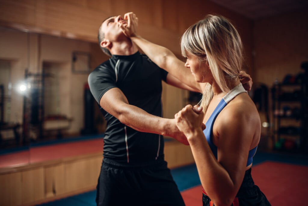 Female Person On Self Defense Workout With Trainer