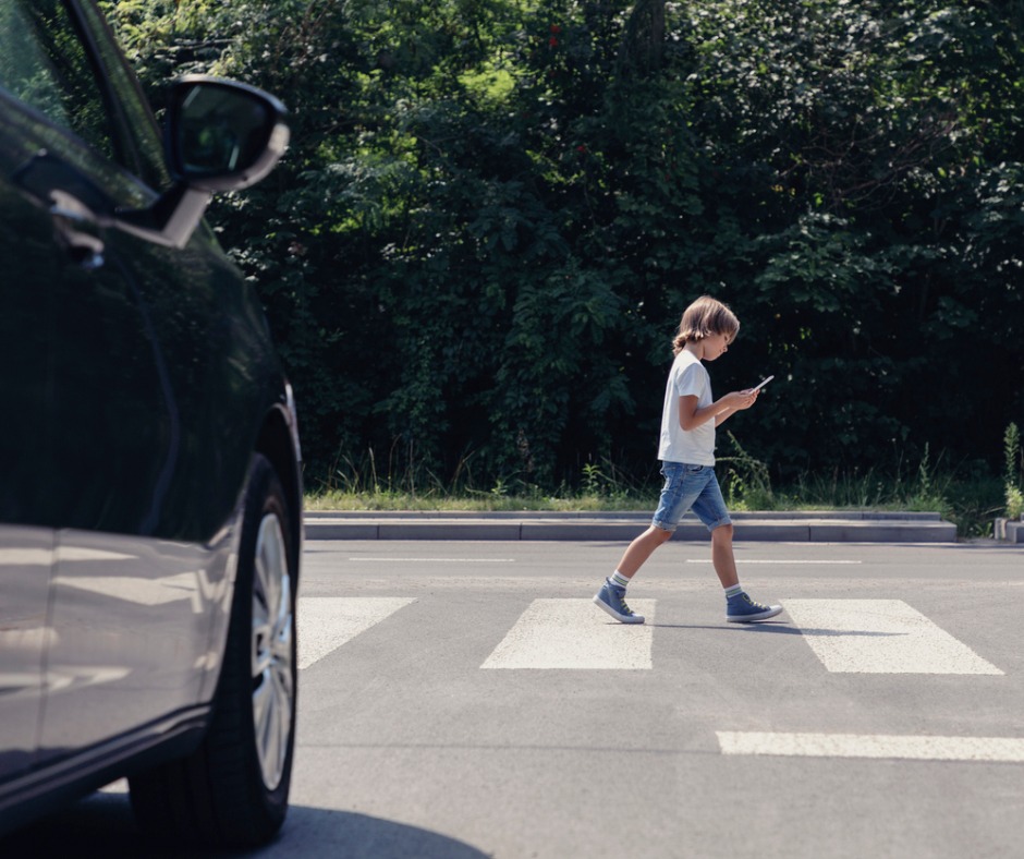 Low Angle Of Car In Front Of Pedestrian Crossing And Walking Boy With Picture Id1152269806