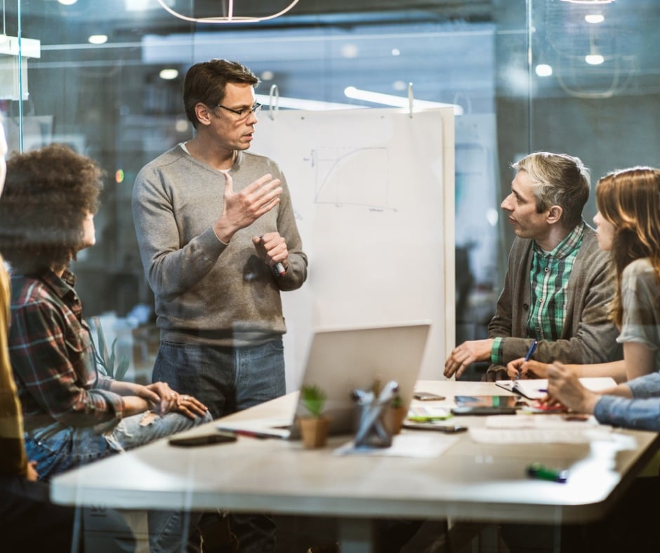 Mid Adult Businessman Talking To His Colleagues On Presentation In Picture Id1127305026