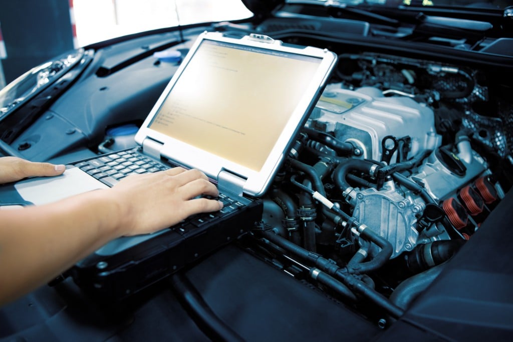 Mechanic Using Diagnostic Machine Tools For Car