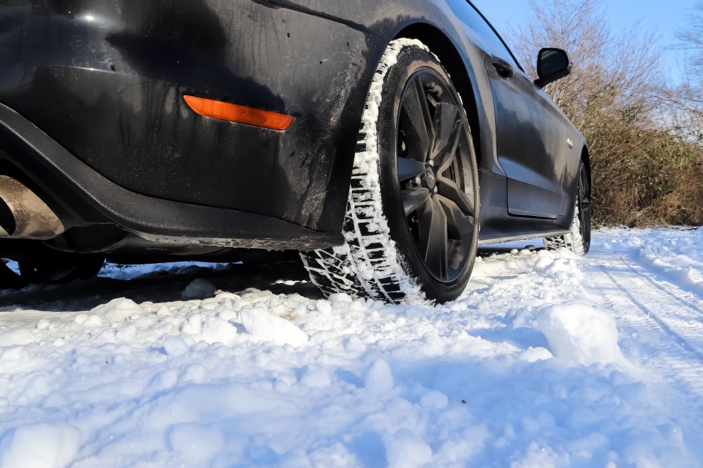 Black Sports Car In Front Of A Winter Landscape In Germany On A Sunny Day.