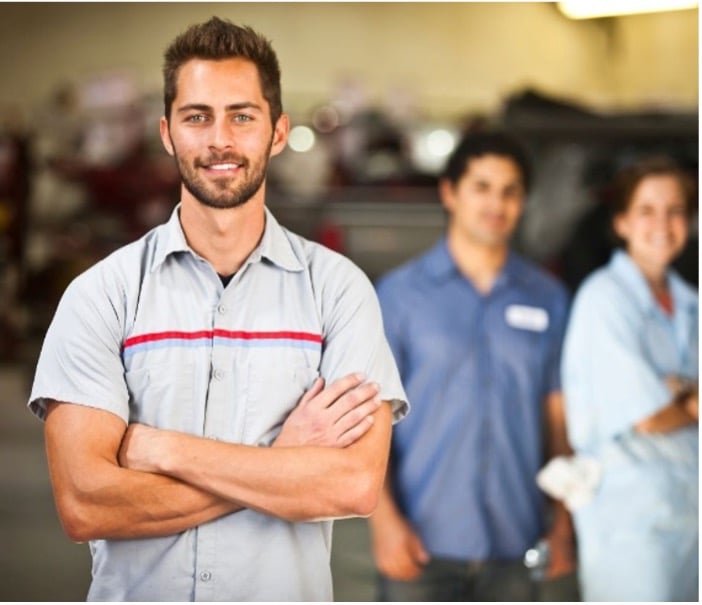 Technician arms crossed. Two techs in the background