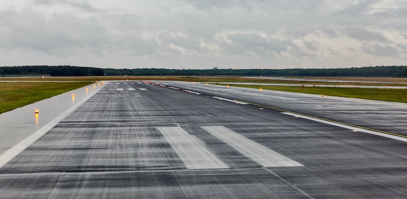 Empty Runway At The Passenger Airport In The Rain