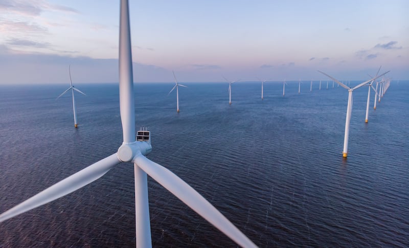 Windmill Park Green Energy During Sunset In The Ocean, Offshore Wind Mill Turbines Netherlands