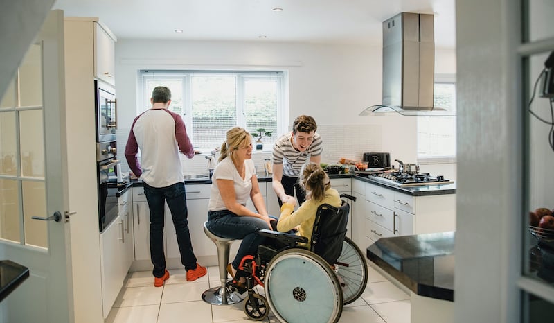 Family Life In The Kitchen With Disabled Daughter