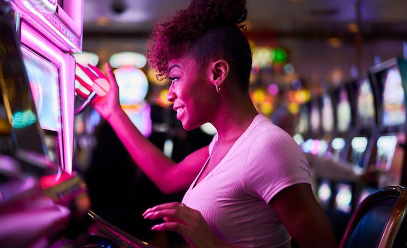Happy Woman Gambling At Casino Playing Slot Machine