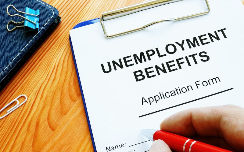 Man Fills In Unemployment Benefits Application Form.