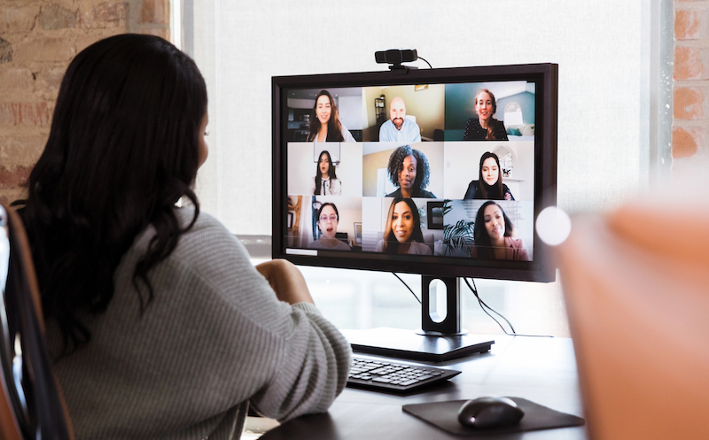 Businesswoman Meets With Colleagues During Virtual Staff Meeting