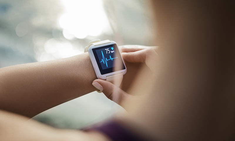 Woman Looking At Her Smart Watch For A Pulse Trace