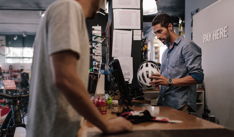 Shop Owner Selling Helmet To Customer